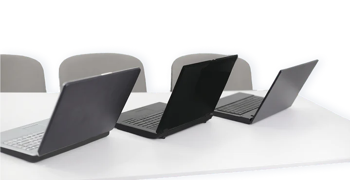 Laptops auf einem Konferenztisch als Symbol für WLAN und Netzwerkanbindung.